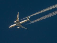 Plane with contrails