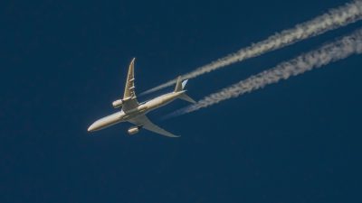Plane with contrails