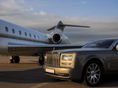 : Private executive airplane with limousine Rolls Royce Phantom luxury car shown together at international Heathrow Airport. VIP service at the airport. Business-class transfer