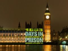 Free Jimmy Lai protestors project message onto Parliament.