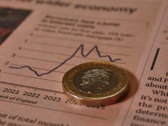 A £1 coin on the Financial Times newspaper illustrates the impact of interest rate changes on currency and equity markets