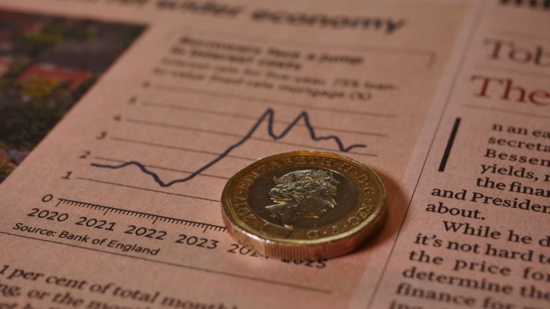 A £1 coin on the Financial Times newspaper illustrates the impact of interest rate changes on currency and equity markets