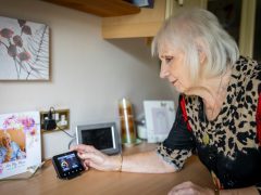 Woman Adjusting Energy Smart Meter.