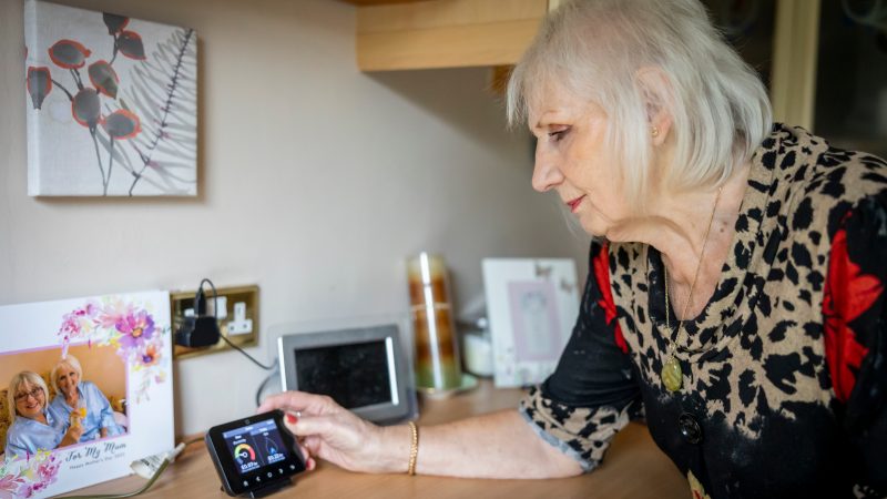 Woman Adjusting Energy Smart Meter.