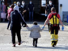 Migrant families with children arrive on Kent beach at Dungeness after being rescued at sea crossing the English channel by RNLI and Border Force.