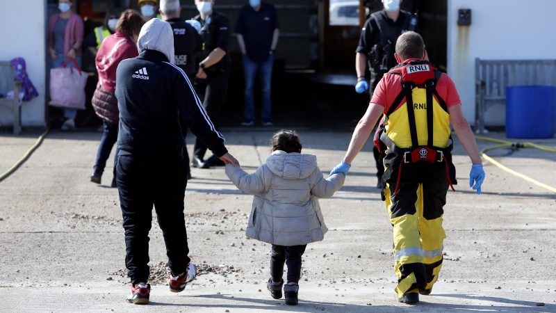 Migrant families with children arrive on Kent beach at Dungeness after being rescued at sea crossing the English channel by RNLI and Border Force.