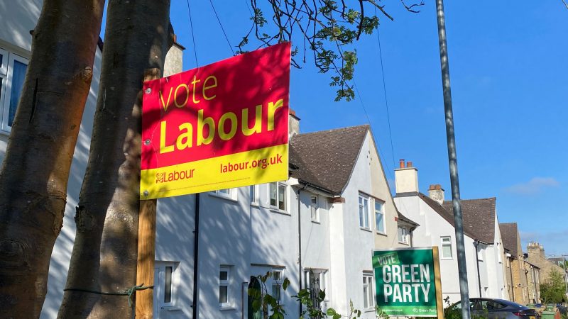 Labour and Green garden stakes next door to each other