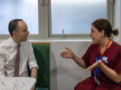 James Murray talking to an NHS worker in scrubs