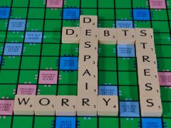 Money worry words on a scrabble board