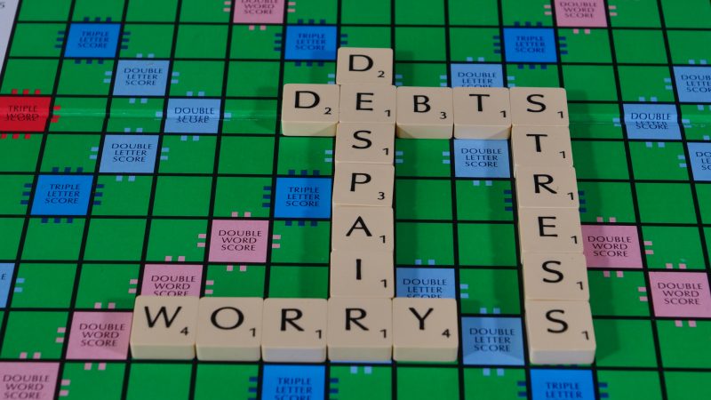 Money worry words on a scrabble board