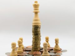 Economic inequality depicted with coins and chess pieces