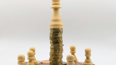 Economic inequality depicted with coins and chess pieces