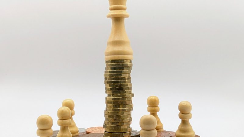 Economic inequality depicted with coins and chess pieces