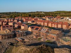Aerial panoramic landscape view of a new build housing estate with houses under construction