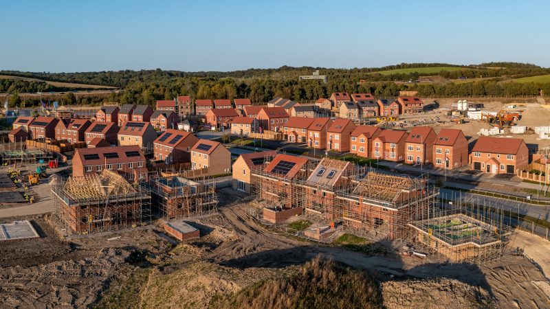 Aerial panoramic landscape view of a new build housing estate with houses under construction