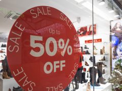Red 50 Percent Off Discount Sale Sign on Store Window.