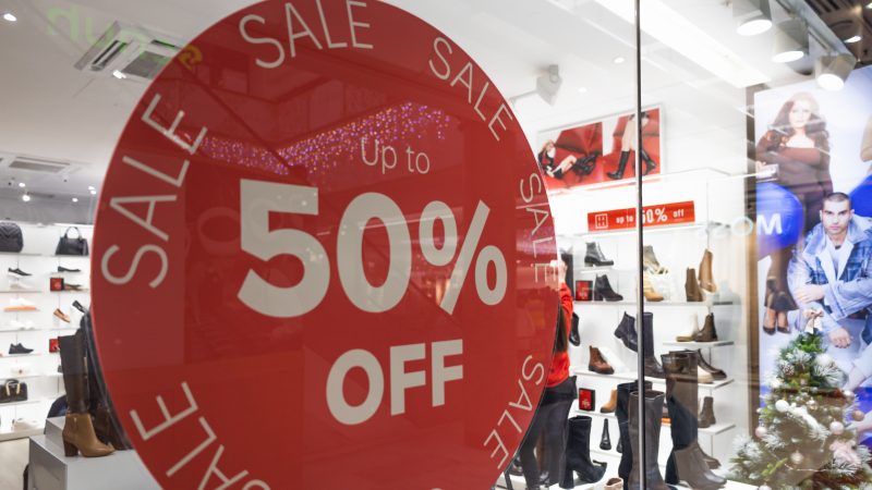 Red 50 Percent Off Discount Sale Sign on Store Window.